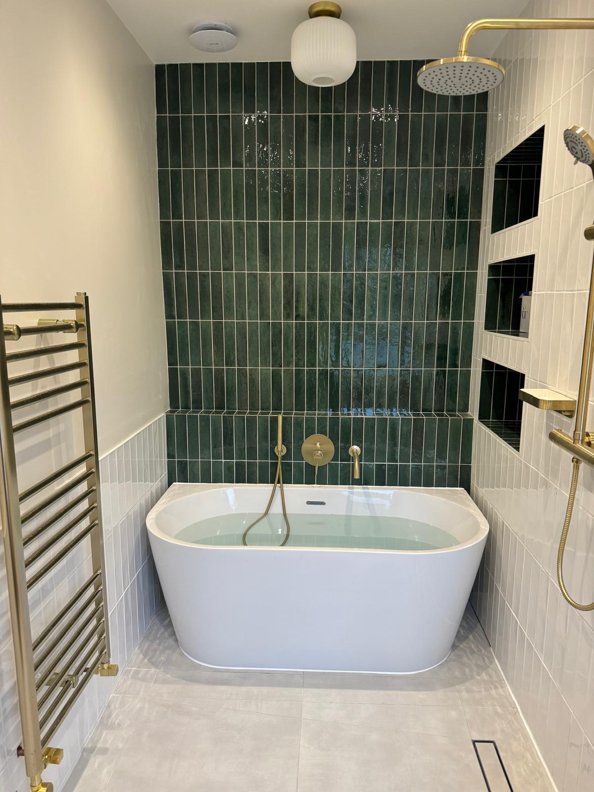 Bathroom refit — finished bath and gold shower fittings