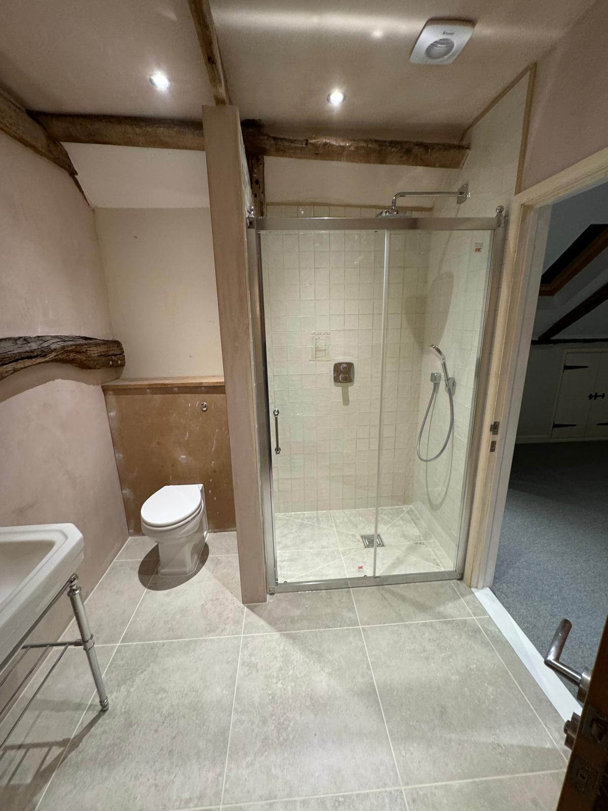 Loft conversion — finished landing with new carpet and en-suite doorway