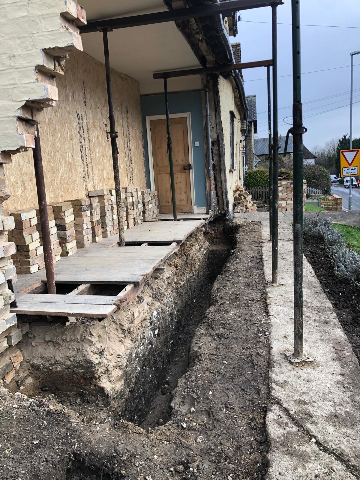 Period renovation — foundations exposed and underpinned along the front wall